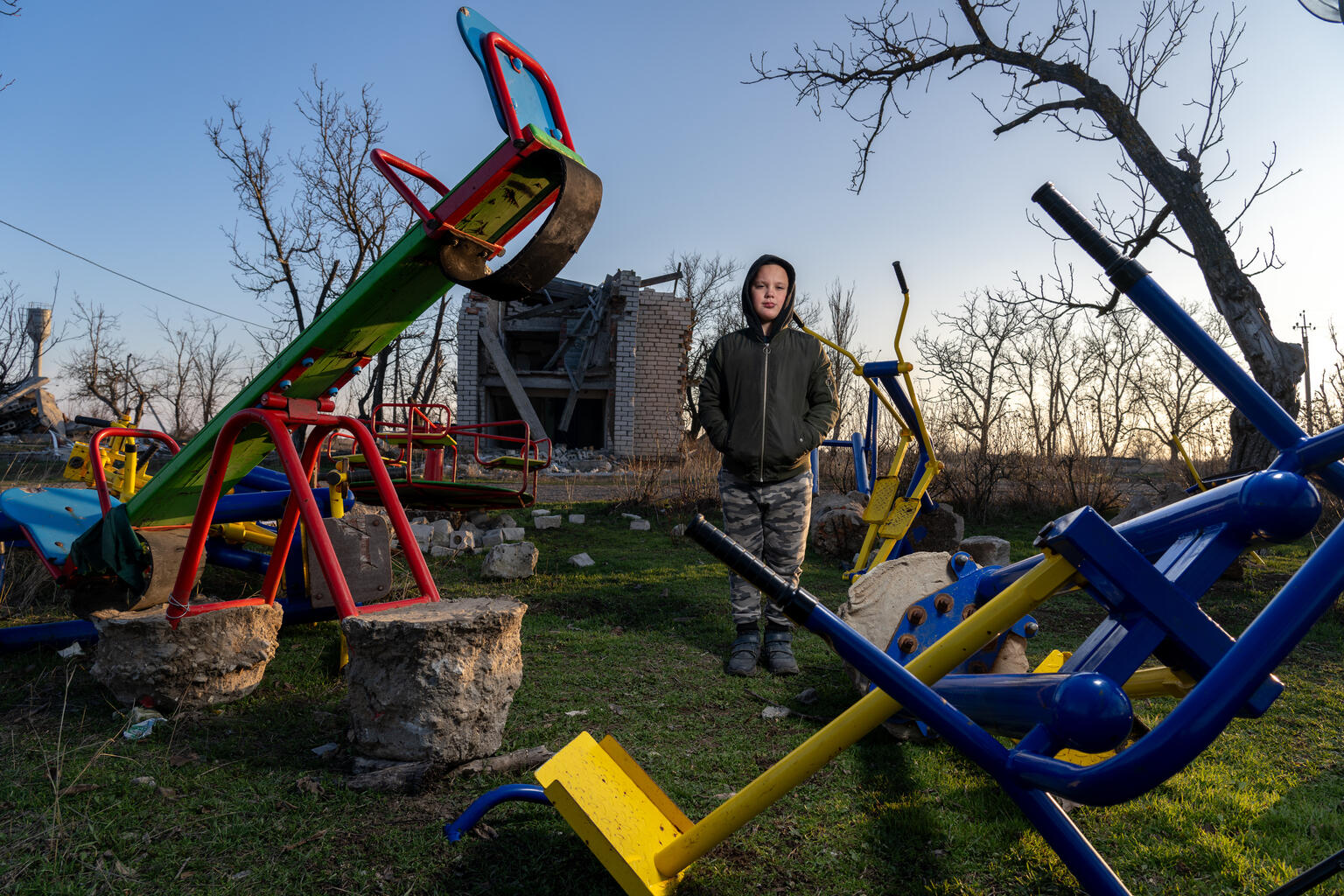 Timofii, 11 years old, stands in front of the ruins of the kindergarten he once attended in the village of Partyzanske, Mykolaiv region, destroyed by shelling.
